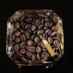 glass ashtray filled with coffee beans