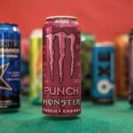 variety of energy drinks in front of a red background