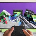 5 tubs of powder-based energy drinks in white sand in first person shooter game on tv screen