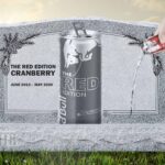 Image of a can of cranberry Red Bull on tombstone